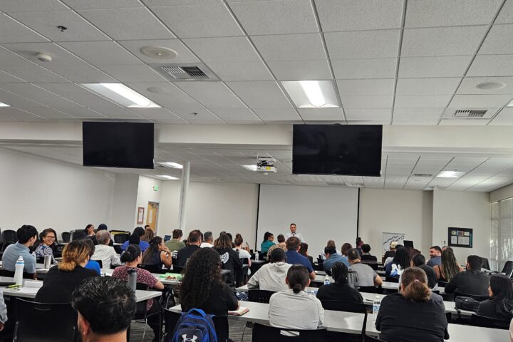 Group of service providers seated in a room during an orientation presentation.